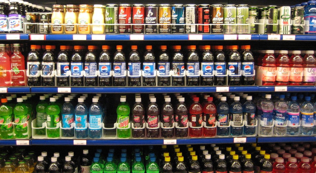 Rows of soda and other sweetened beverages at a grocery store.
