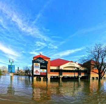 Floodwaters cover a shopping center in Peoria, Illinois.
                  