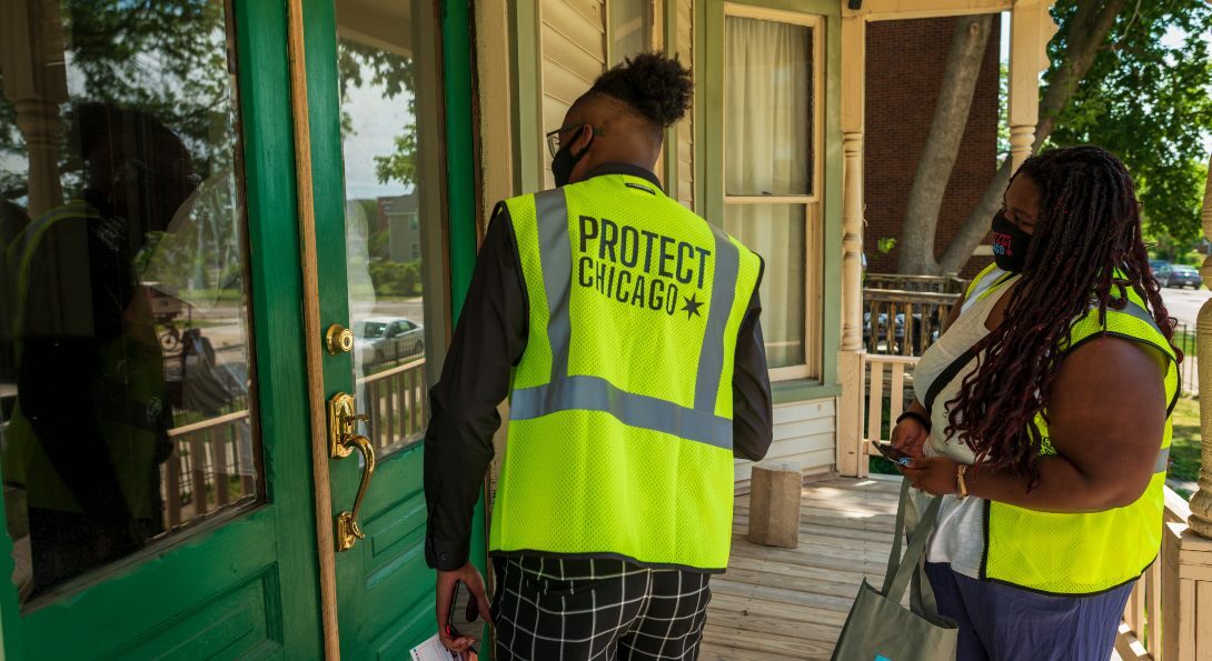 ChiTracing Corps members canvas door-to-door in Chicago's Englewood neighborhood to promote COVID-19 vaccine access.
