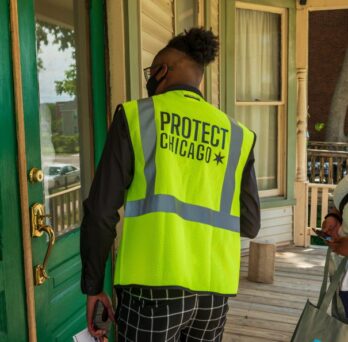 ChiTracing Corps members canvas door-to-door in Chicago's Englewood neighborhood to promote COVID-19 vaccine access.
                  