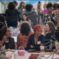 Image of nonprofit leaders sitting and talking at a convening.