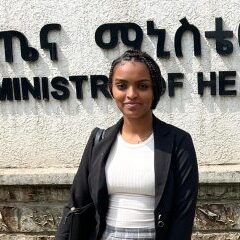 Tigist Mersha in front of MOH sign in Addis Abbaba.