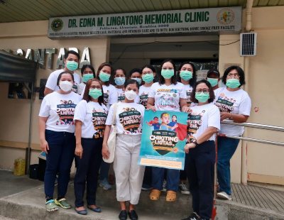 Thea and nurses for the Chikiting Ligtas vaccine campaign posing with a campaign poster.