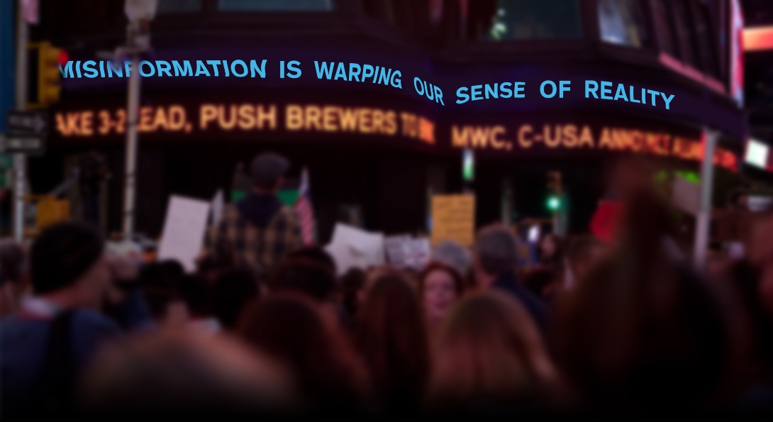 An image of people assembled in New York City's Times Square, with news tickers flashing information.  One of the tickers has been edited to read:  
