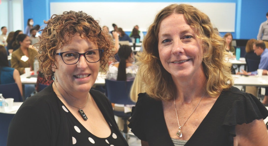 Alisa Velonis and Jeni Hebert-Beirne pose for a photo in an SPH classroom.