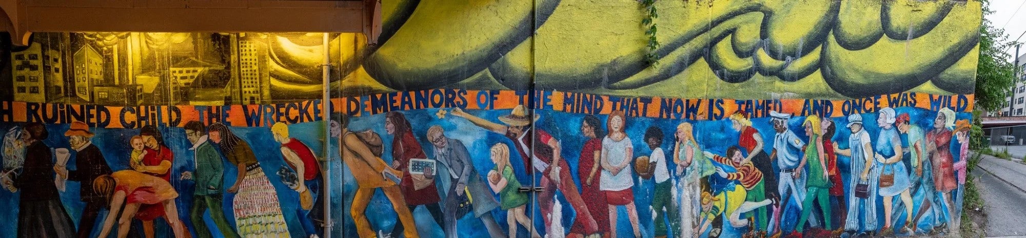 An underpass on Chicago's south side contains a mural showing a wide variety of people, with differences in age, size and ethnicities.