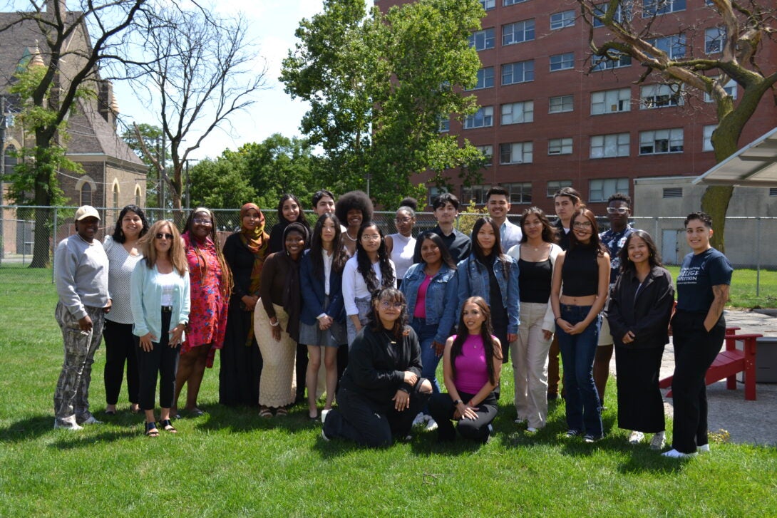 Undergraduate students posing outside of the School of Public Health buidling