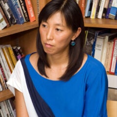 headshot of Naomi Paik at an angle, wearing blue shirt