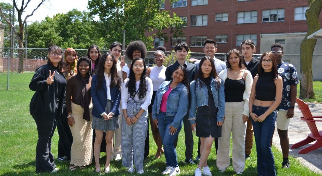 Group of students stand on the lawn by UIC SPH