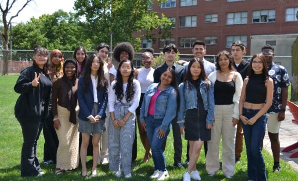 Group of students stand on the lawn by UIC SPH